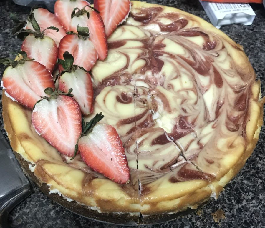 This is a picture of a strawberry cheesecake topped with fresh strawberries. I took this picture to capture my success in making a strawberry cheesecake.
