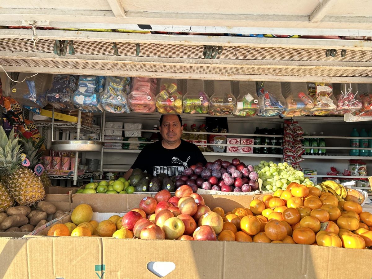Juan González is in his truck showing off his fresh new produce.