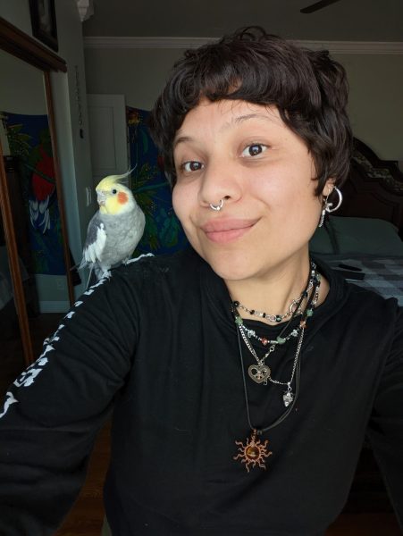 This is a photo of Ms. Frances being with her pet bird that she likes to spend time with.